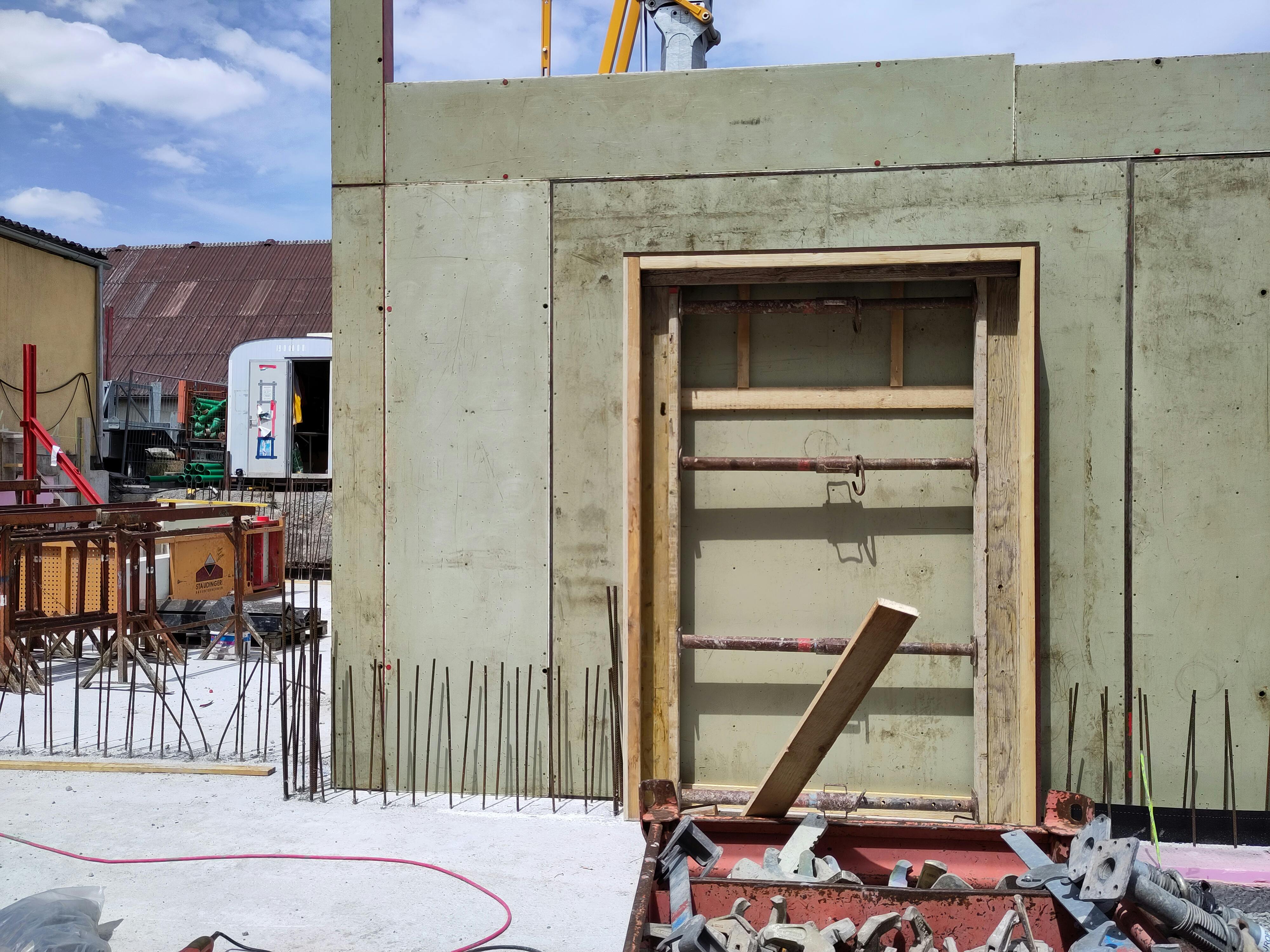 Hierzu werden alle auf Zug belasteten Bauteile durch Bewehrungen aus Stahl verstärkt, die durch Draht miteinander verbunden sind. Alle Wände werden anschließend geschalt. Die Schalung dient dem Beton primär als Form und leitet dabei die entstehenden Kräfte in die Unterkonstruktion ab. Bereits am nächsten Tag kann die Schalung wieder entfernt werden und das Untergeschoss nimmt allmählich Konturen an. Das beiden Zugangstore zum Mostereibereich sind erkennbar ebenso wie die Verbindung zum späteren Flur.